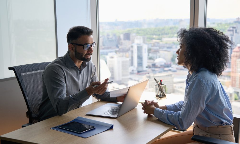 Indian latin hr manager on interview with African American applicant in office.