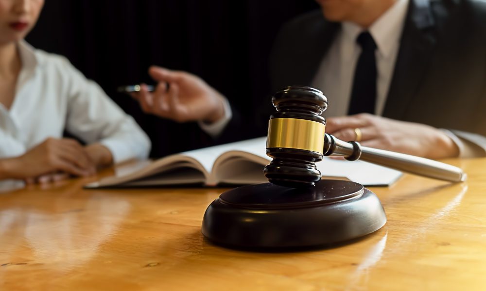 Judge gavel with Justice lawyers having team meeting at law firm background